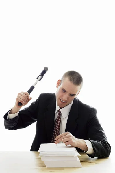 Businessman Hammering Nail Stack Papers — Stock Photo, Image