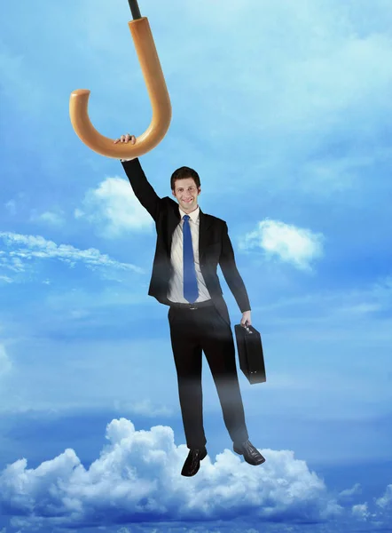 Businessman Holding Flying Umbrella — Stock Photo, Image