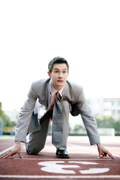 Businessman getting ready on the running track
