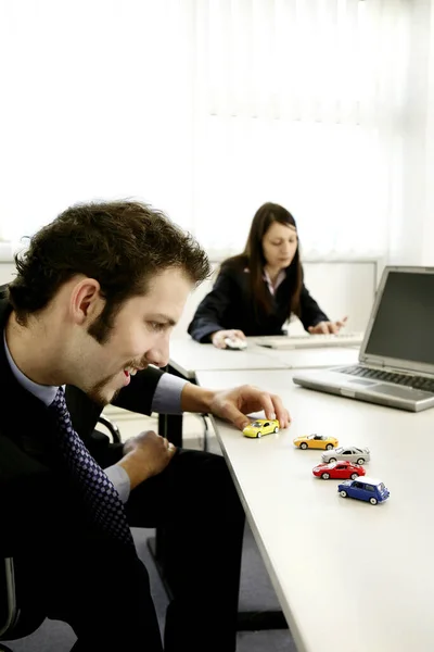 Businessman Playing Toy Cars — Stock Photo, Image