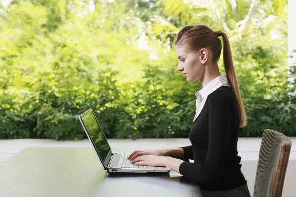 Woman in formal wear using laptop