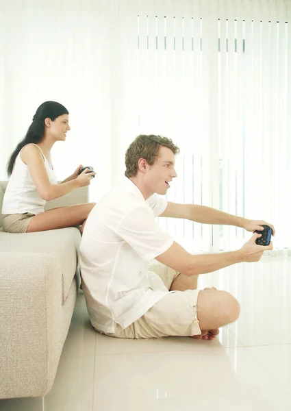 Couple playing with video game console
