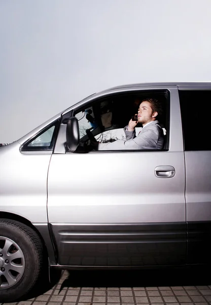 Businessman Talking Phone While Driving Car — 图库照片