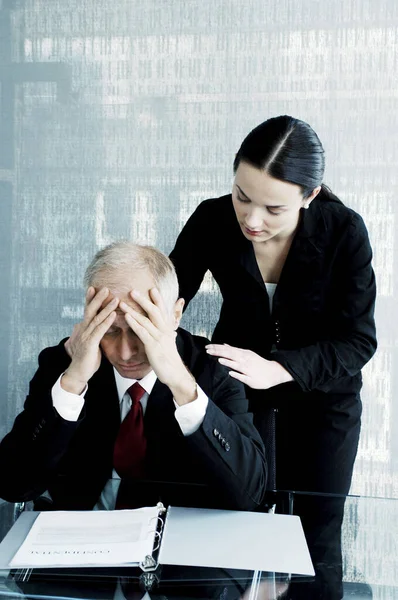 Woman comforting a stressed out businessman