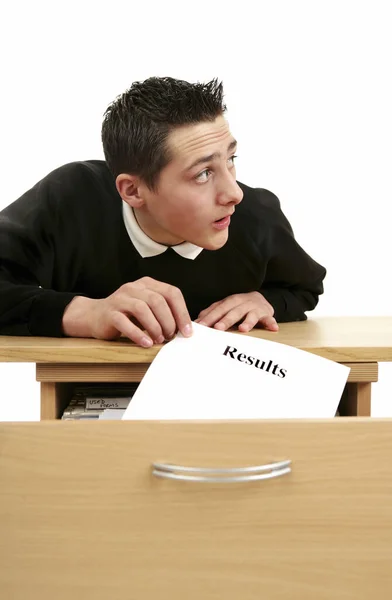 Boy stealing a sheet of exam results