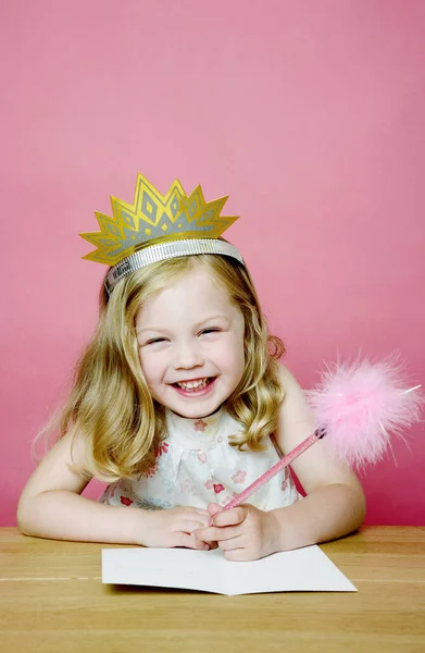 Girl Smiling While Drawing Royalty Free Stock Images