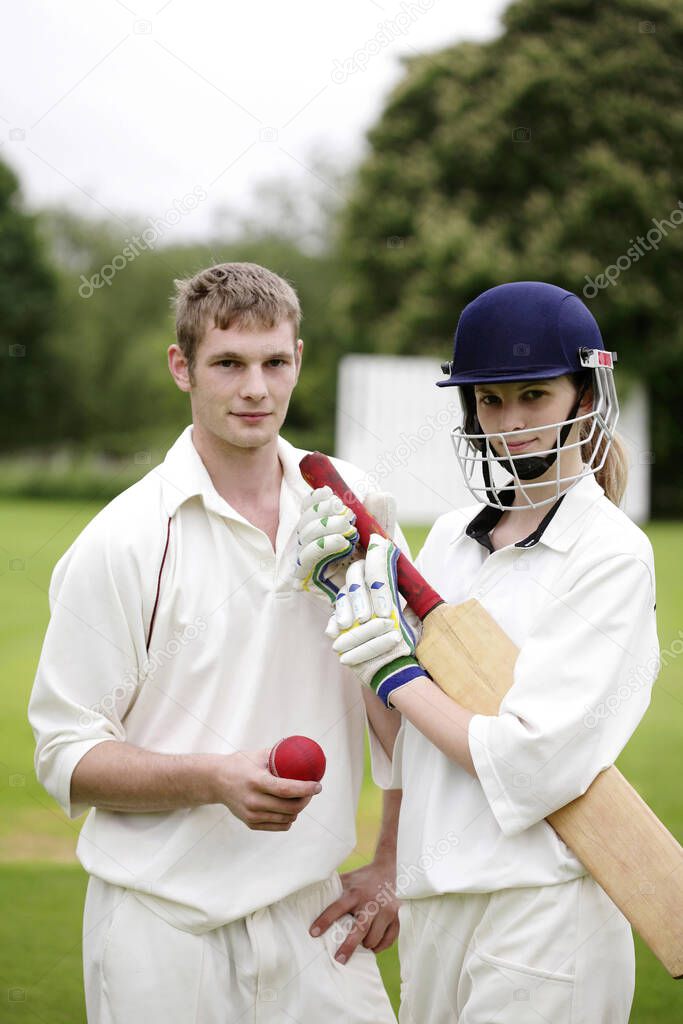 Man and woman holding a cricket bat and a cricket ball