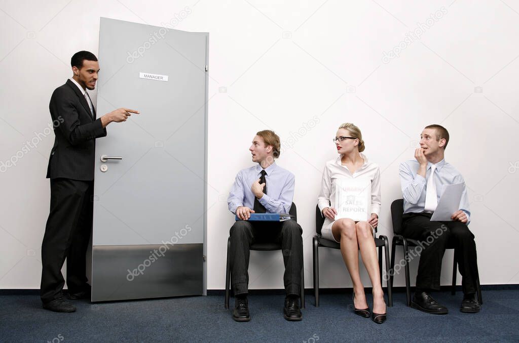 Business people waiting for their turn to be interviewed