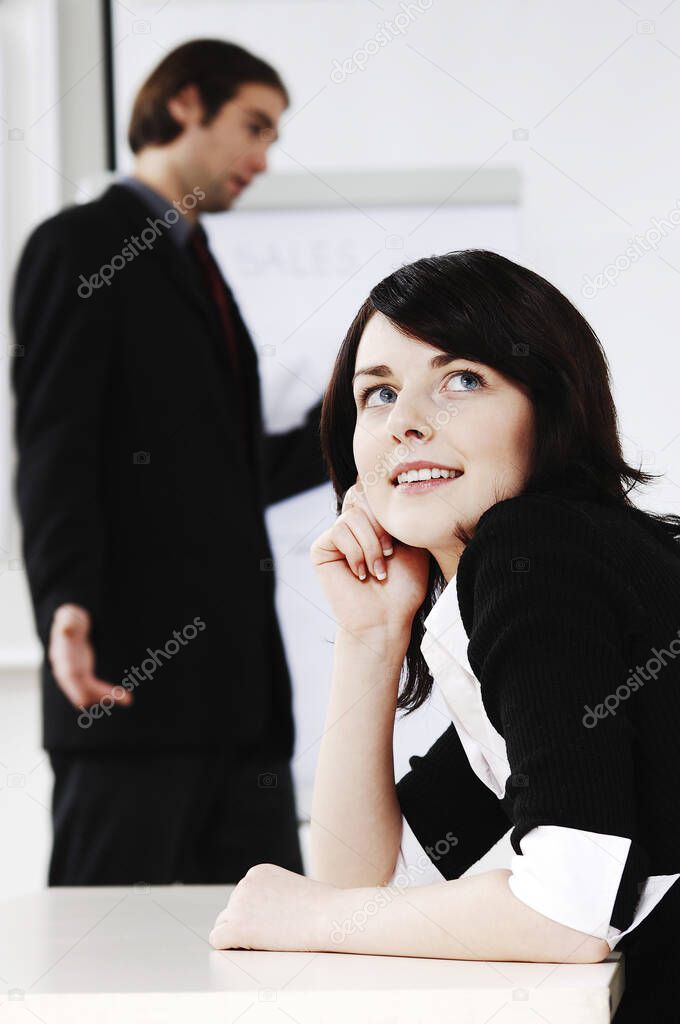young businesswoman daydreaming at office