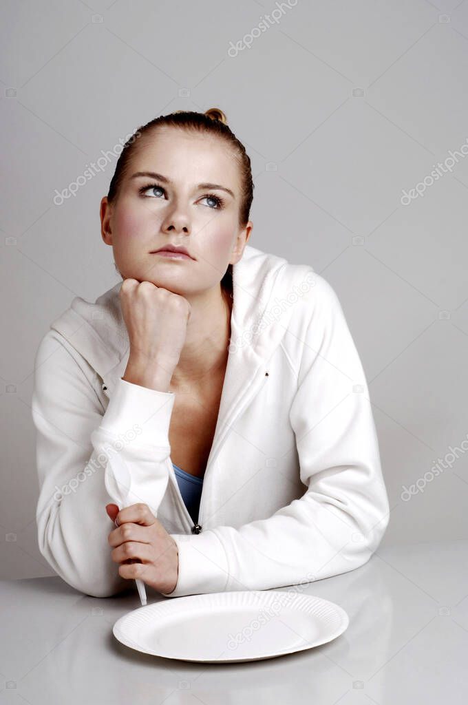 Woman daydreaming, studio shot