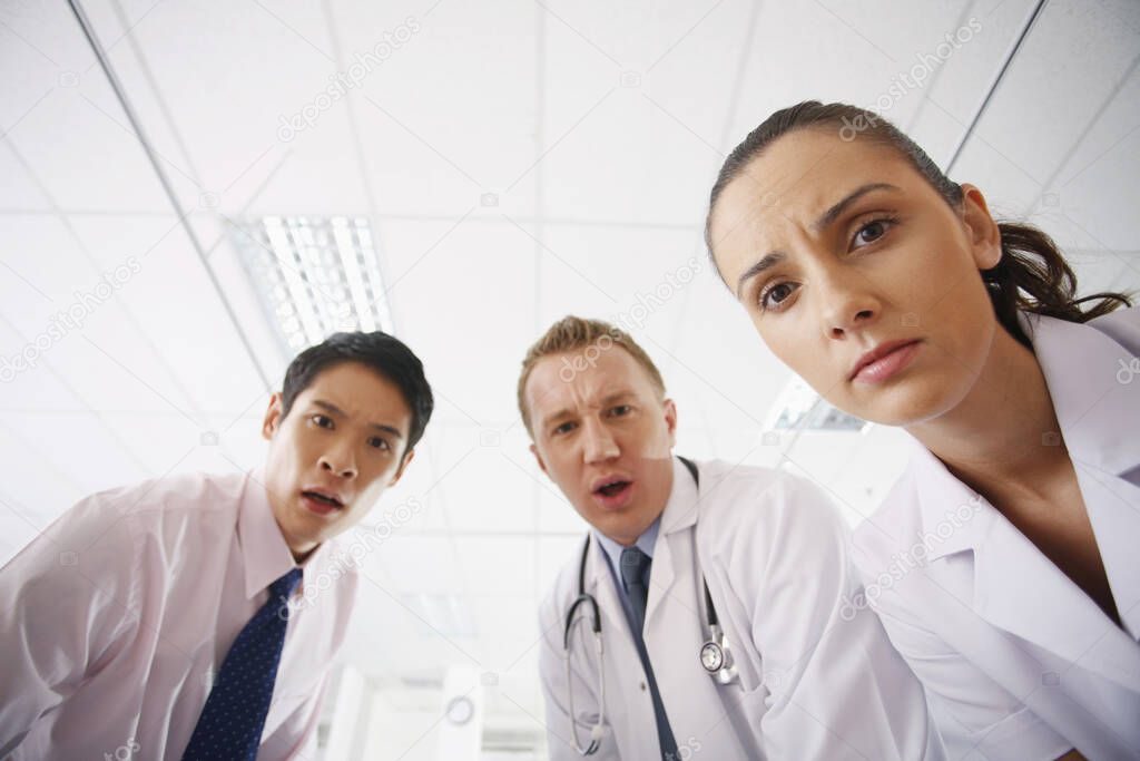 Medical professionals in shock looking at camera
