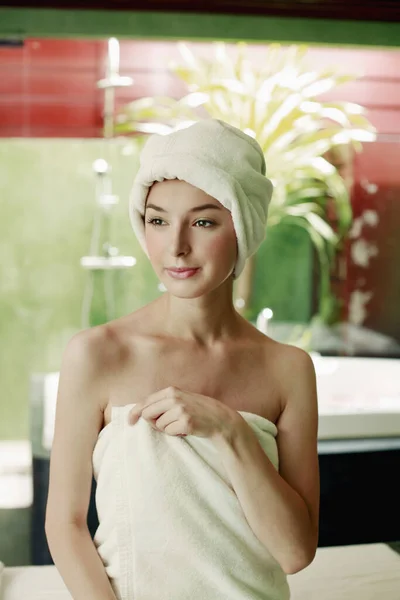Woman in towel with hair wrapped in towel