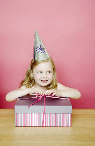 Girl Unwrapping Her Present — Stock Photo, Image