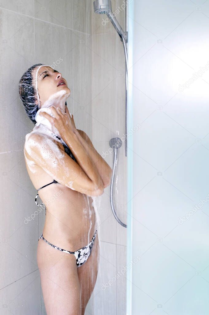Woman taking shower at home