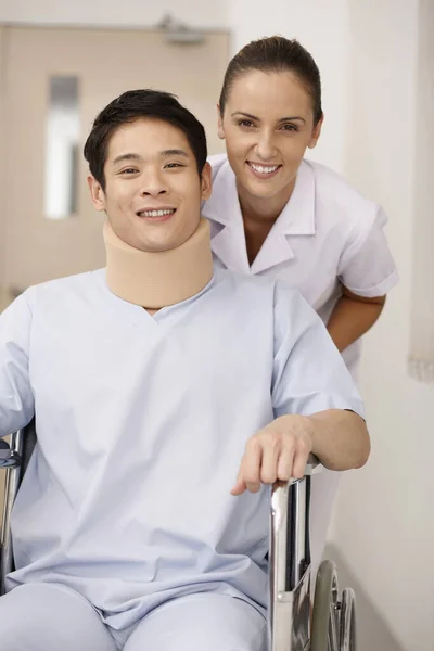 Nurse Pushing Patient Wheelchair — Stock Photo, Image