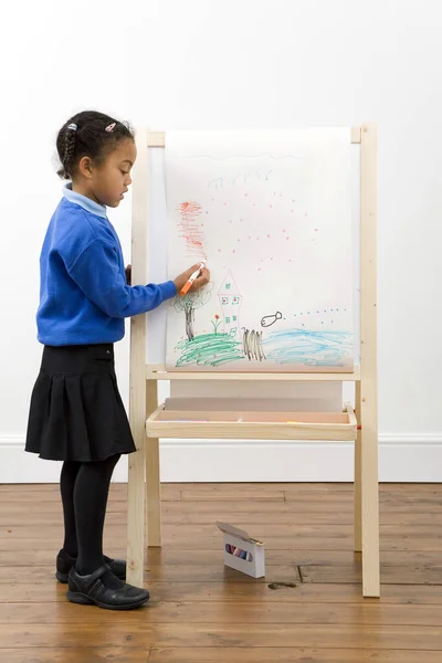 Girl drawing on drawing board