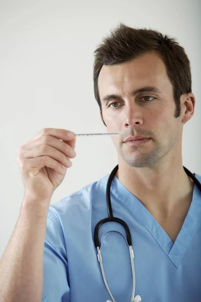 Médico Masculino Olhando Para Termômetro — Fotografia de Stock
