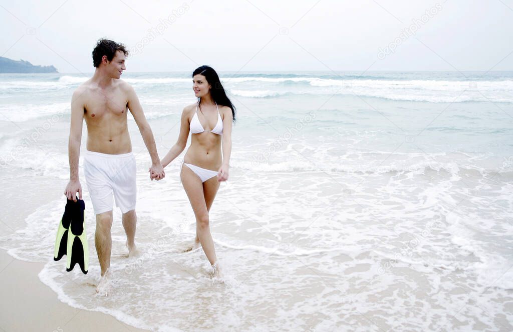 Couple taking a stroll along the beach