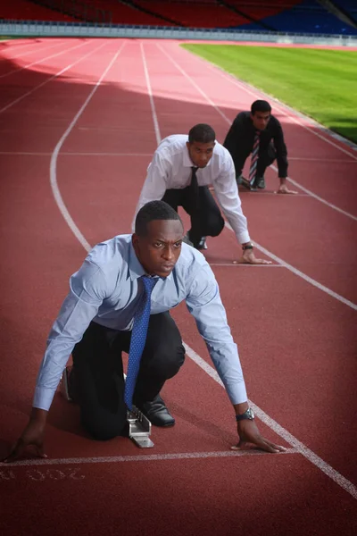 Business people crouching on starting line