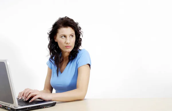 Woman Thinking While Using Laptop Stock Picture