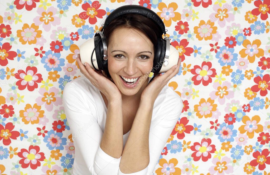 Woman smiling while listening to music on the headphones