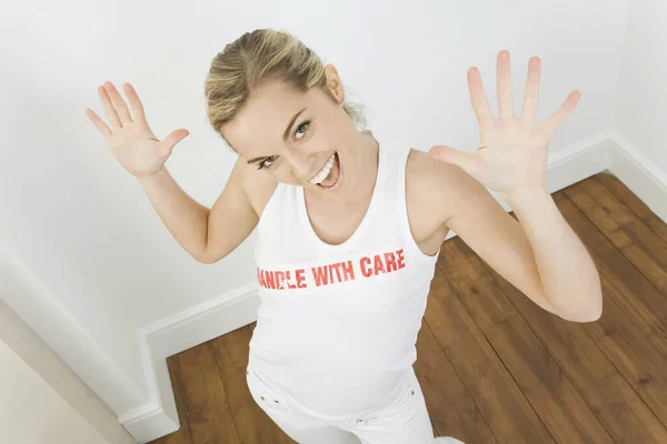 Woman with the word 'handle with care' on her sleeveless top