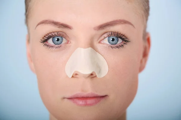 Woman with cleansing strip on her nose