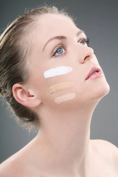 Woman with three shades of foundation on cheek