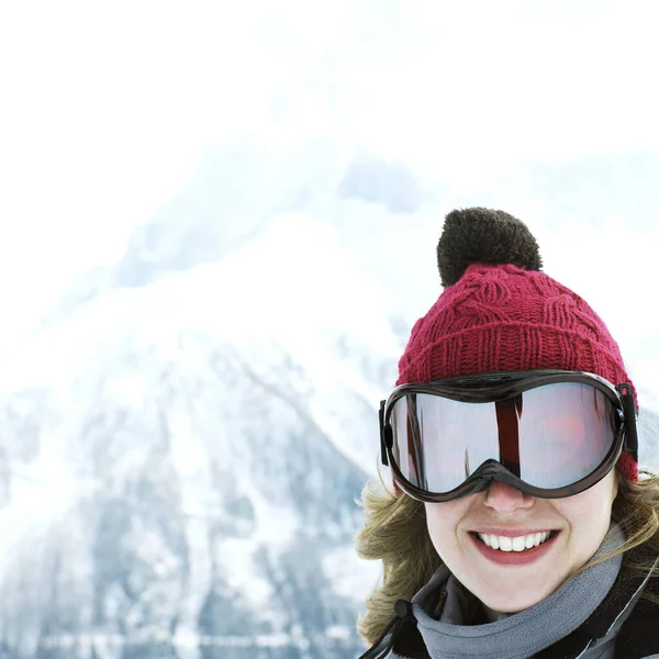 Woman in knitted hat and ski goggles