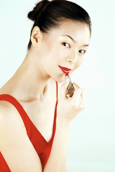 Studio Shot Lady Red Dress Applying Red Lipstick — Stock Photo, Image