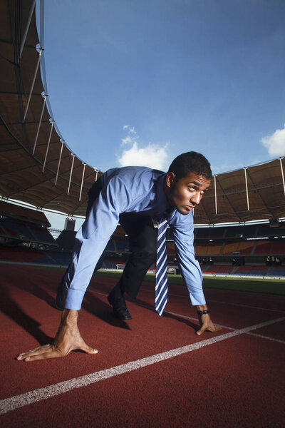 Businessman crouching on starting line