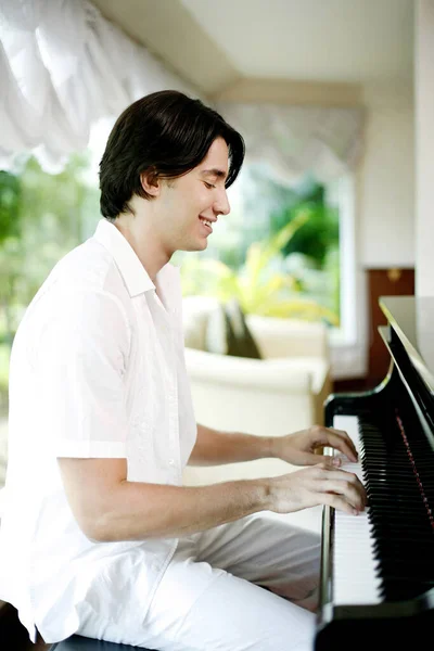Handsome man playing piano