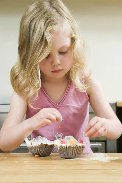 Girl Decorating Cupcakes Colourful Candies Royalty Free Stock Images