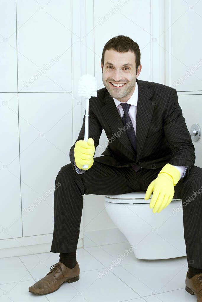 Businessman with rubber gloves holding a cleaning brush
