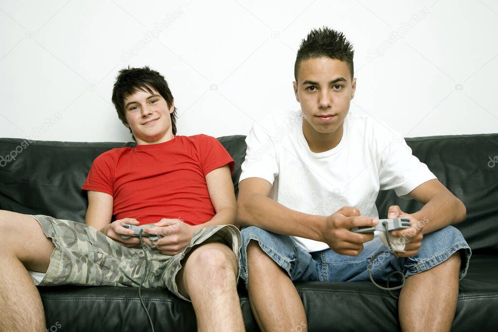 Boys playing video game console