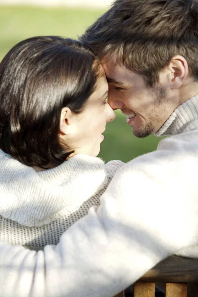 Couple Looking Each Other While Sitting Bench — Stockfoto