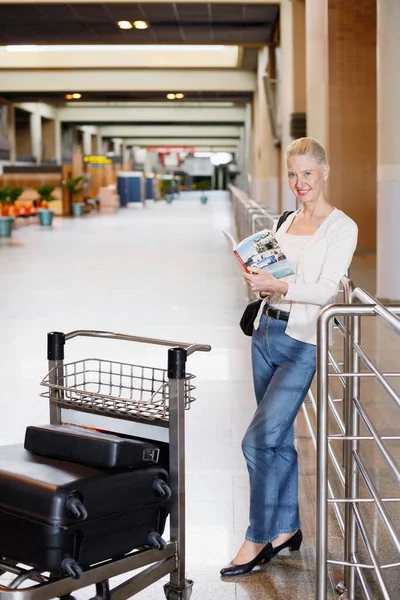 Mujer Leyendo Libro Viaje Con Carrito Equipaje Delante Ella — Foto de Stock