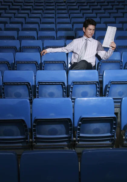 Businessman Reading Newspaper Empty Stadium — Stock Photo, Image