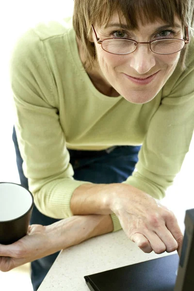 Mujer Sosteniendo Una Taza Café Mientras Usa Ordenador Portátil — Foto de Stock
