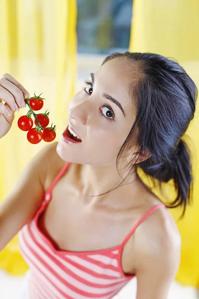 Woman eating cherry tomatoes