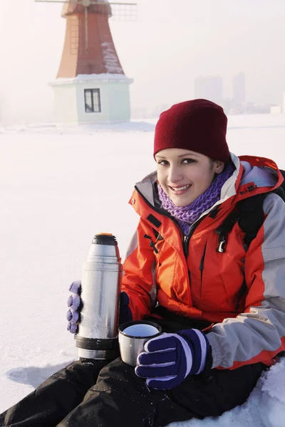 Woman enjoying hot drink on winter day