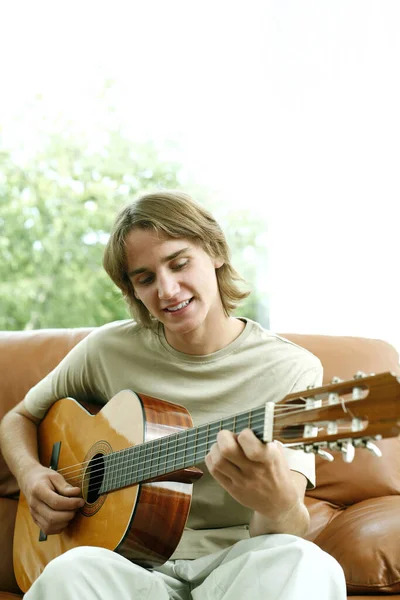 Teenage Boy Sitting Couch Playing Guitar — Stock Photo, Image