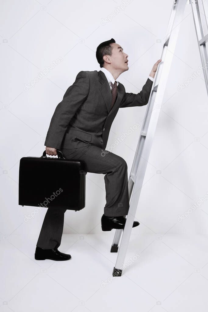 Businessman climbing up the corporate ladder