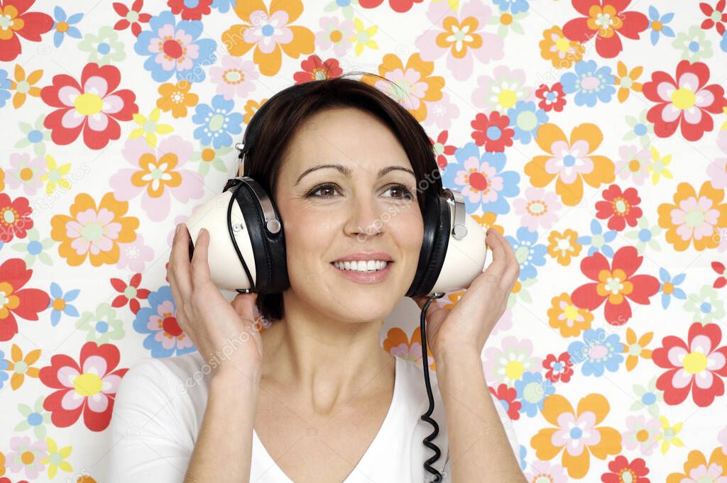 Woman smiling while listening to music on the headphones