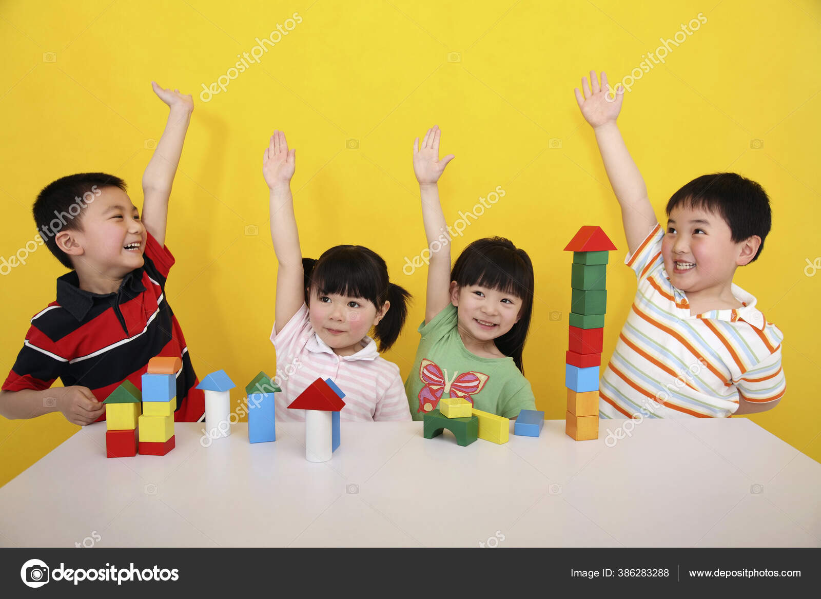Children Playing Building Blocks Raising Hands — Stock Photo © image