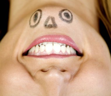 Woman with a face drawn on her chin
