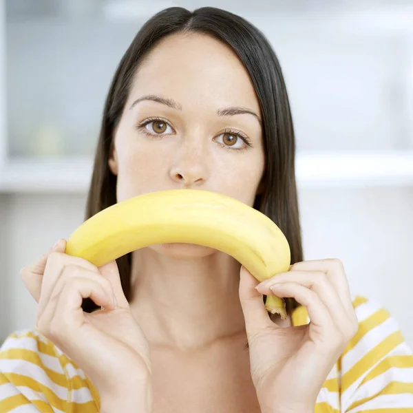 Woman using banana as a sad face