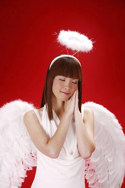 Young woman in angel costume