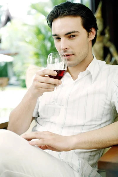 Homem Segurando Copo Vinho Tinto Enquanto Sorri Para Câmera — Fotografia de Stock