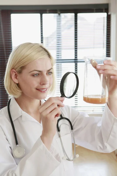 Woman Examining Liquid Beaker — Stock Photo, Image